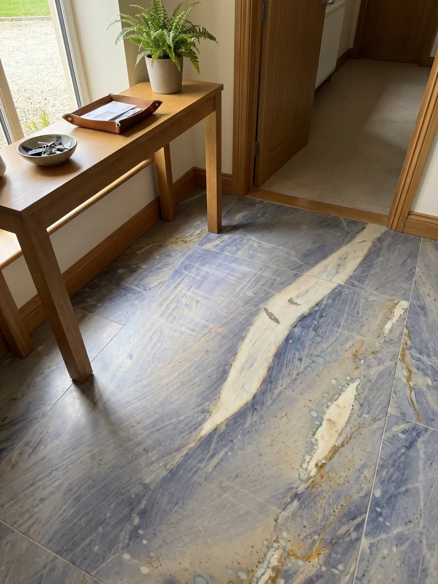 Piso de recibidor en placas grandes de Cuarcita Azul Macaubas con luz natural: fondo azul lavanda con una gran franja crema en diagonal y toques ocre