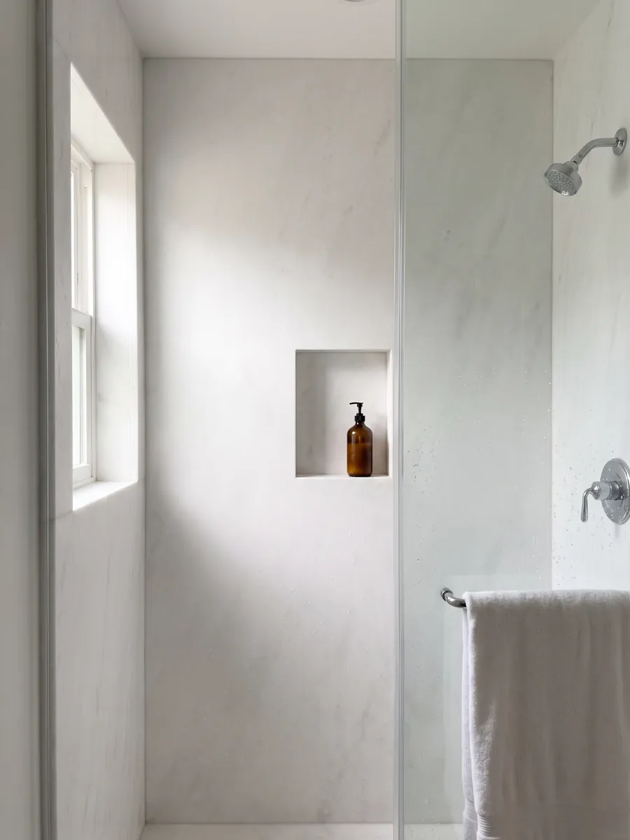 Ducha revestida con placas enteras de Mármol Blanco Ghiaccio con nicho empotrado: blanco puro casi sin dibujo visible