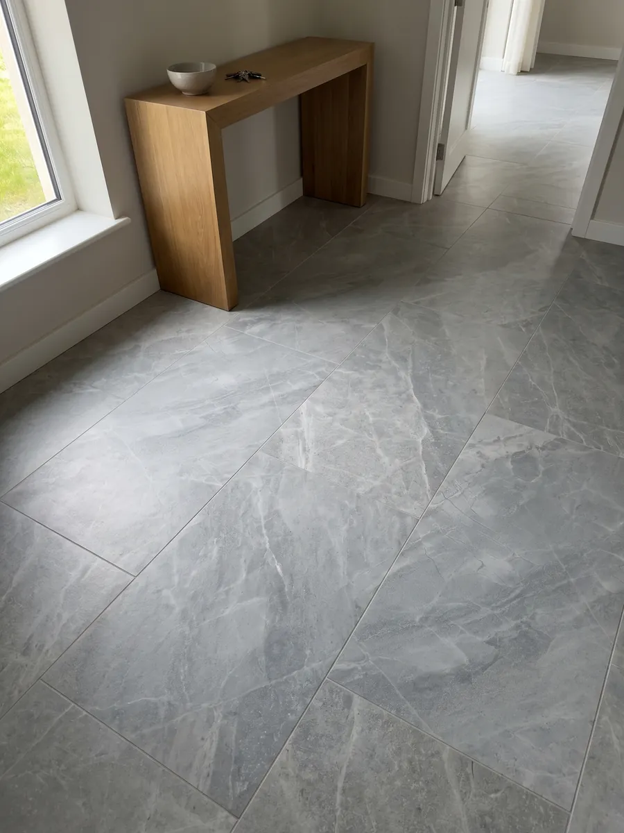 Piso de recibidor en placas grandes de mármol gris Bleu de Savoie con luz natural: gris azulado con vetas claras finas en red y nubes más claras