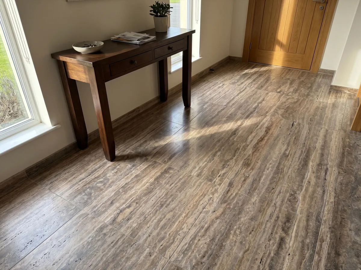 Piso de recibidor en placas grandes de travertino marrón Pantheon con luz natural: marrón con franjas horizontales finas y paralelas más claras