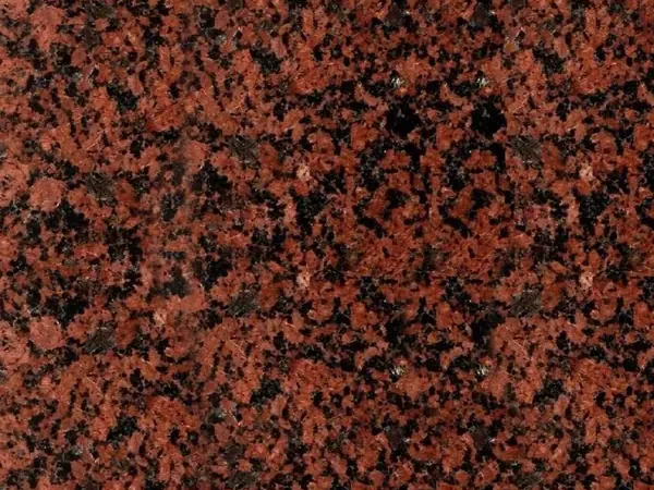 Placa de Granito Balmoral Red: fondo rojo ladrillo con puntos negros repartidos y sin vetas