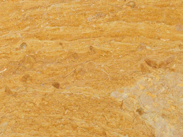 Detalle del Mármol Amarillo Real: bandas onduladas de ocre y naranja sobre el fondo amarillo