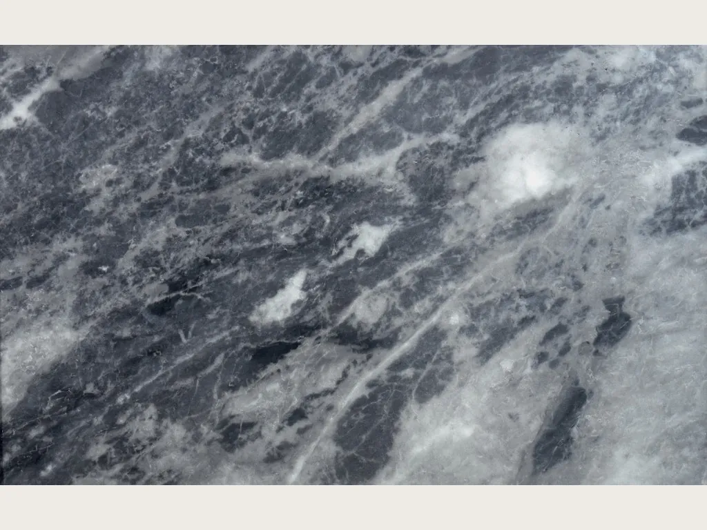 Placa de mármol gris Bardiglio Nuvolato: fondo gris oscuro azulado con nubes y vetas blancas grisáceas en diagonal, acabado pulido