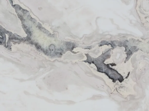 Detalle del Mármol Dover White: recorrido irregular de la veta gris oscura entre ondas beige