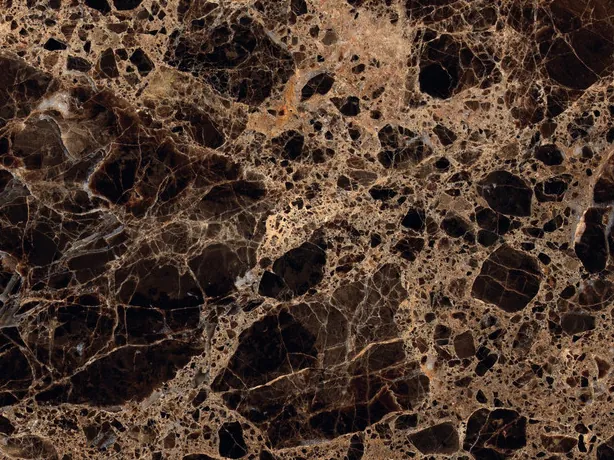 Detalle del Mármol Emperador Oscuro: red de vetas beige y marrón claro alrededor de manchas oscuras