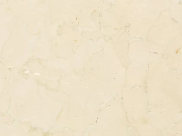 Detalle del mármol beige Pietra Orsera: red suave de vetas beige sobre el fondo crema claro