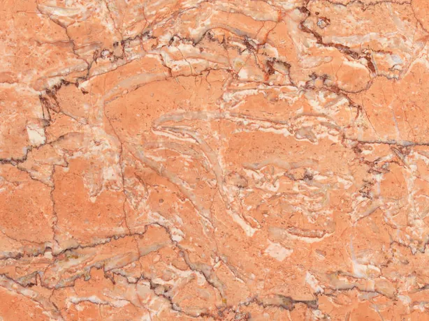 Detalle del Mármol Rosa Sabrina: vetas finas blancas y rojizas sobre el naranja salmón pulido