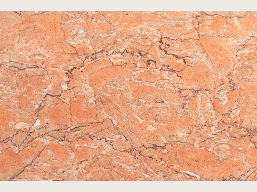 Placa de Mármol Rosa Sabrina: fondo naranja salmón con red densa de vetas finas blancas y marrón rojizo
