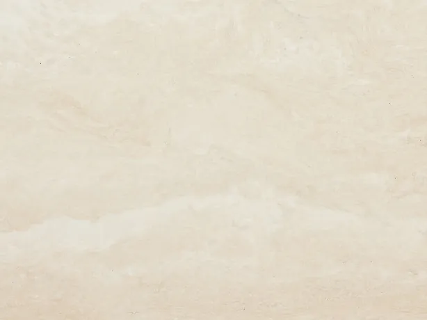 Detalle del Travertino Blanco: dibujo nublado y ondas horizontales suaves sobre el crema marfil